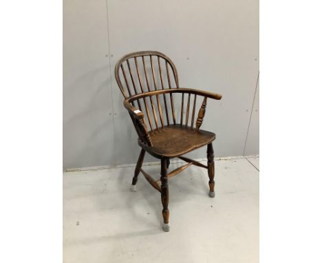 A mid 19th century Windsor elm and beech comb back elbow chair, width 62cm, depth 38cm, height 98cm