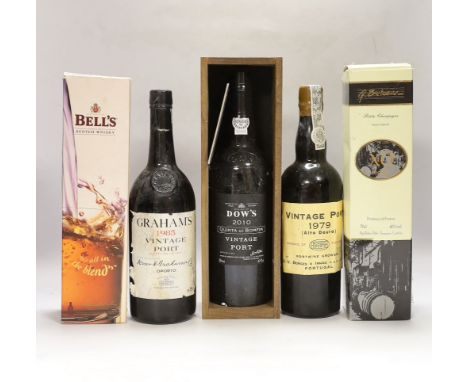 Three bottles of vintage port: A Grahams 1985, a Portuguese Alto Douro 1979, a Dow’s 2010 together with a boxed Bell’s Scotch