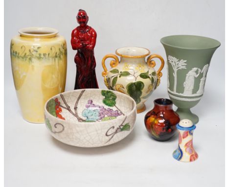 Five ceramic items including a Wedgwood pedestal vase, a Ruskin lustre glaze vase, a Doulton flambé 'The Genie', etc.