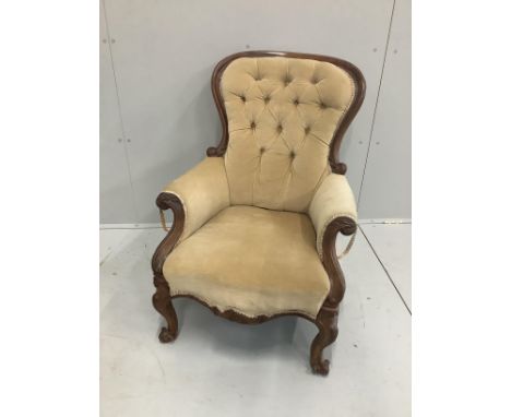 A Victorian carved mahogany button back armchair, width 70cm, depth 80cm, height 88cm