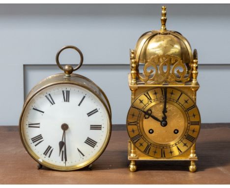 An early 20th Century round brass drum clock along with mid 20th Century reproduction lantern clock.
