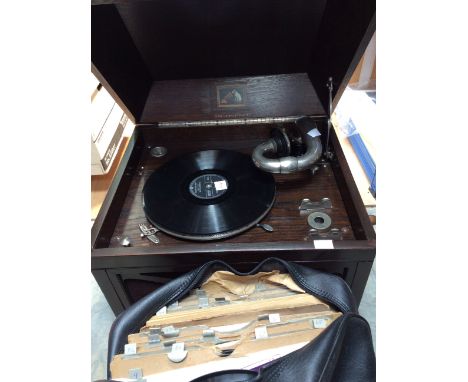 A mid 20th Century his masters voice table top gramophone along with a collection of 78 records.