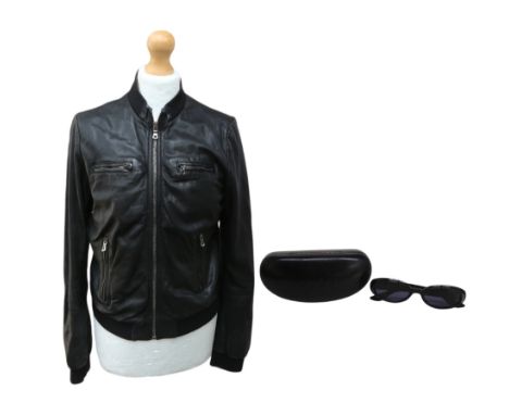 A Dolce and Gabbana black leather jacket with elasticated waistband and zip fastening, size 30" chest along with a pair of Gu