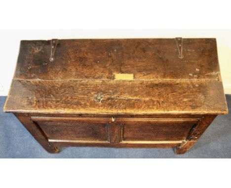 A mid 17th Century oak two panel English coffer with plank top, uncarved, standing on block legs. L96cm x H54cm x W41Conditio
