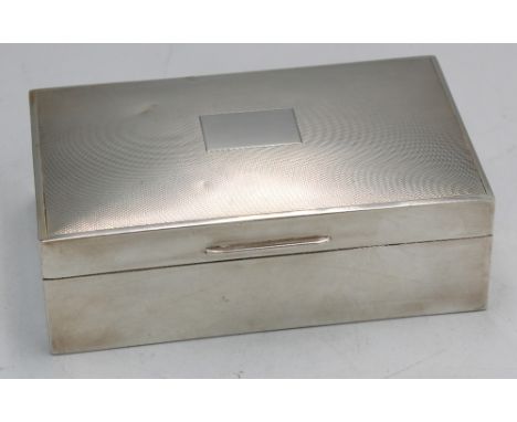 An Elizabeth II silver cigar box, of rectangular shape with leather base and cedarwood interior, cover with engine turned dec