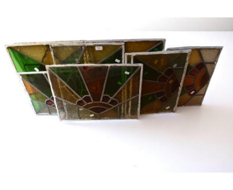 A collection of ten early to mid 20th century stained glass window panels with lead , in red, green and yellow colourways, of