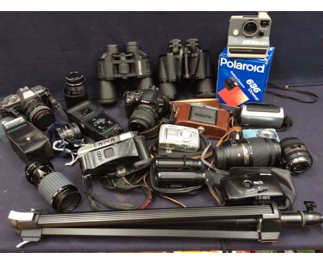A collection of mid to late 20th Century cameras, video cameras, accessories, binoculars and more including lenses.