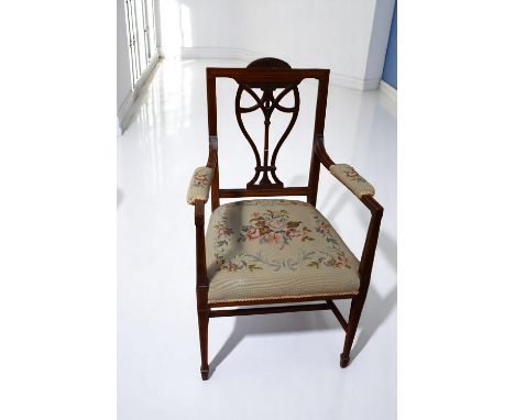 An Edwardian mahogany ornate armchair with boxwood inlay and tapestry seat and arms.