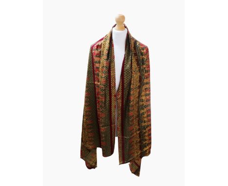 A length of Asian silk in a colourway of golds featuring camels with a claret hemline. Label attached. Indonesia. Approximate