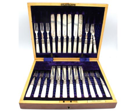 A cased set of twelve Edwardian silver and mother of pearl fruit knives and forks, each with decorative silver ferrules and p