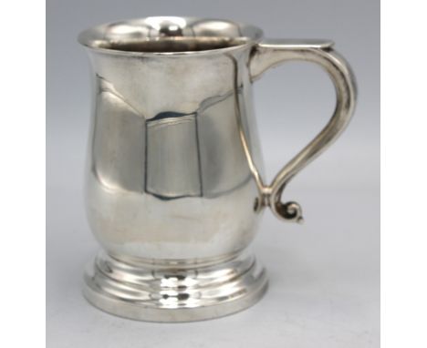 An Elizabeth II silver mug or tankard, of plain design with stepped circular base and scrolled handle, hallmarked by WA Humph