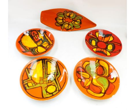 Four orange Poole mid 20th Century bowls along with a spear head orange Poole dish. (5)