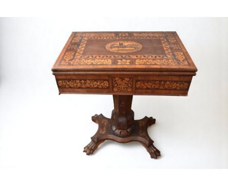 A 19th century Irish Killarney marquetry and yew games table, with hinged rectangular top decorated with central ruined abbey