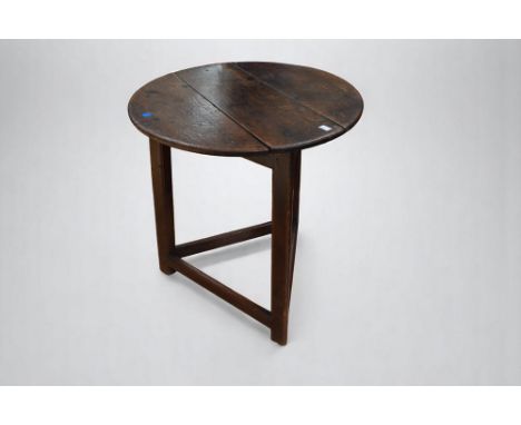 A late 17th Century cricket/tavern oak table with round planked top triangular supports and stretchers.