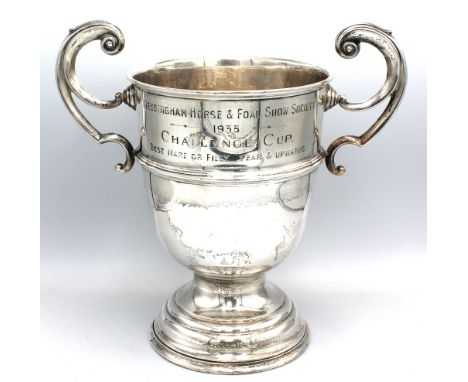 A George V silver large presentation trophy, of usual shape with twin scrolled handles and upon stepped circular base, body e
