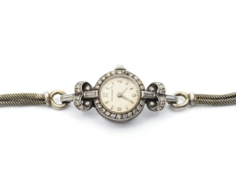 A ladies Movado 1930's diamond set platinum wristwatch, comprising a round silvered signed dial with applied Arabic and arrow