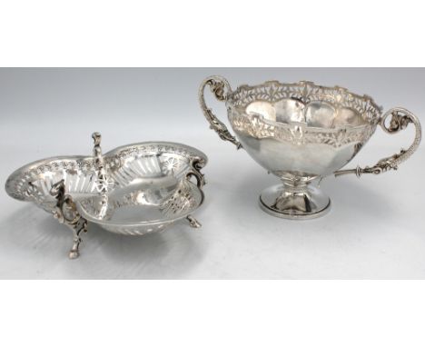 A George V silver twin handled bowl or trophy cup, with pierced floral border and angular rim, upon circular foot, with mythi