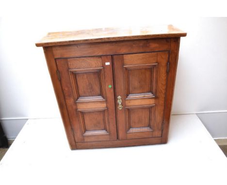 A 18th Century style oak floor standing cupboard with panelled doors concealing two internal shelves along with a collection 
