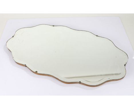 Mid 20th Century wall mirror, of wavy shaped form with bevelled glass mirror, 69cm wide