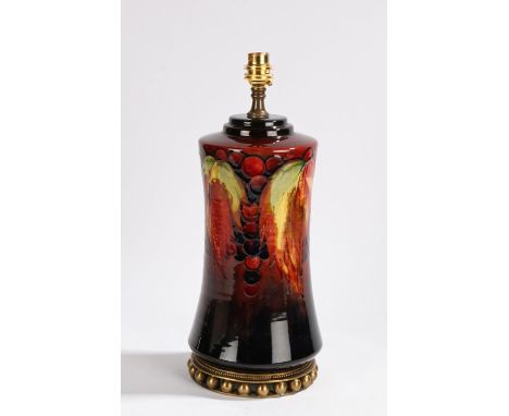 Moorcroft pottery lamp, in the 'Leaf and Berries' pattern, on a flambe ground, 31cm high excluding the shade