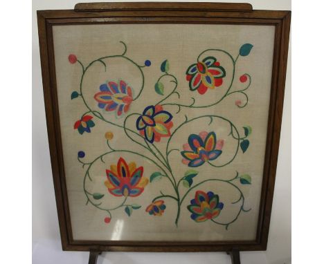 Mid 20th Century oak framed fire screen, inset with a brightly coloured floral embroidered panel within an Art Deco frame, 65