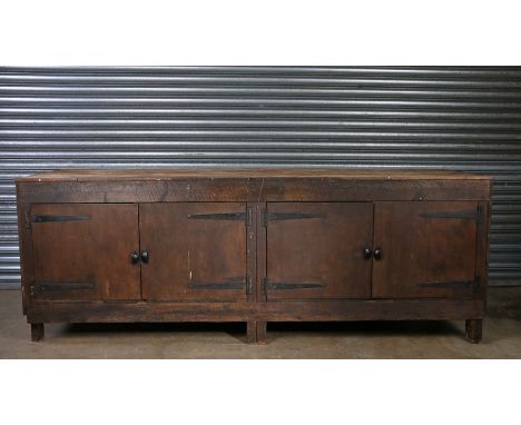 Large 20th Century cobblers work bench, the parquetry top above two pairs of hinged doors enclosing a pine boarded interior w