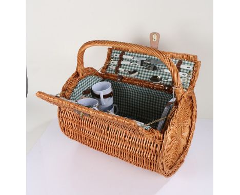 Wicker picnic hamper, of round form with carrying handle, complete with contents, 49cm wide