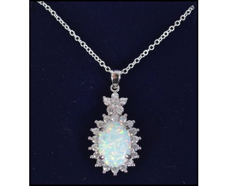 A silver and large opal necklace and pendant surrounded by cz's and set to a fine link chain. Size 43cms / Weight 6.2g