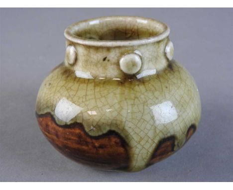 A Chinese Yue Yao ash-glazed jar, Song Dynasty, of squat globular form the neck with six moulded raised roundels, a light oli