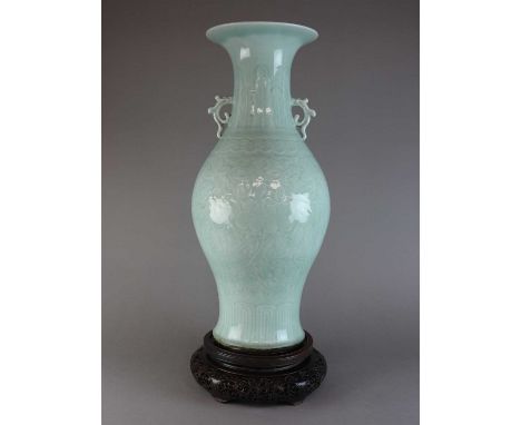 A large Chinese celadon baluster vase, Qing dynasty, early 19th century, the flaring neck above a border of plantain leaves a