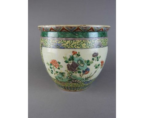 A Chinese famille verte porcelain planter, Qing Dynasty, 19 th century, of swelling round form, decorated with panels of peon