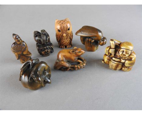 Seven various netsuke and okimono, 20 th century, comprising a wasp on a piece of fruit, a squirrel and wheatear, a shishi, t