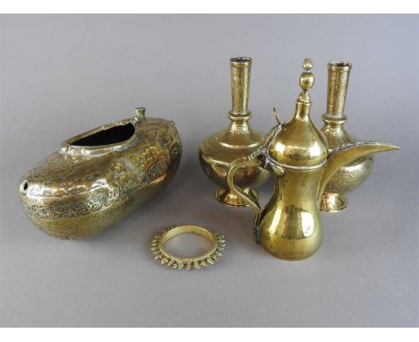 A Qajar Persian brass kashkul, 19th century, the heavily worked and chased body detailed with men drinking and conversing wit
