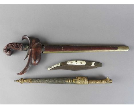 An Afghan pesh kabz and a Javanese kris, 19th century, the pesh kabz with elaborate florally gilded handle and spearhead inci