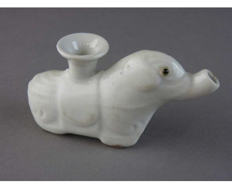 A Chinese export porcelain blanc de chine elephant candlestick holder, Qing dynasty, 18th century, brown glazed eyes, open tr