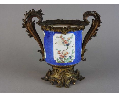 A Chinese ormolu mounted jar, probably Kangxi, panel decorated in famille verte enamels with flowering branches and insects a