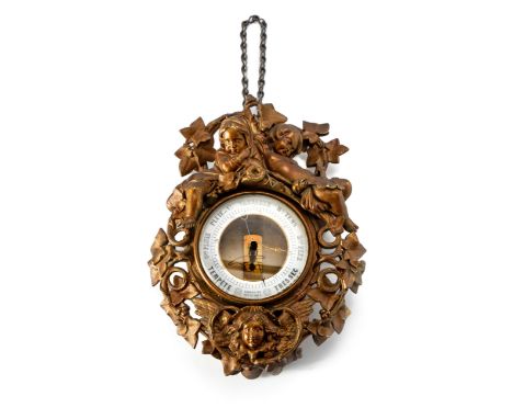 The circular enamel dial within a cast case surmounted by a pair of children sleeping amongst vines35cm high