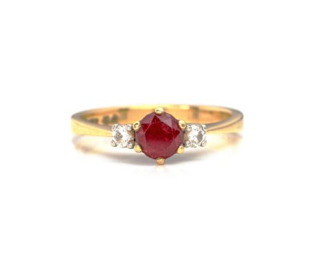 Claw set to the centre with a round mixed-cut ruby weighing approximately 0.61cts, flanked on either side with a round brilli