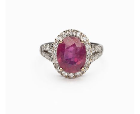 Similar to previous and following lots, claw set to the centre with an oval mixed-cut ruby, enhanced, approximately 11,7 by 9