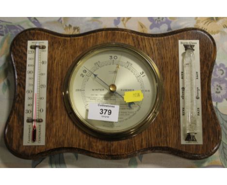 AN OAK FRAMED BAROMETER