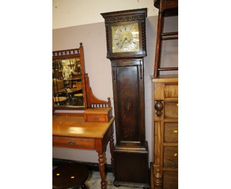 AN EARLY 20TH CENTURY OAK LONGCASE CLOCK WITH BARLEYTWIST DETAIL