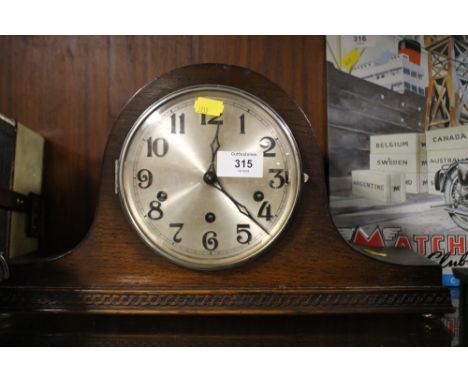 AN OAK NAPOLEON HAT MANTEL CLOCK