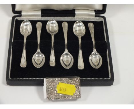 A HALLMARKED SILVER MATCH BOOK HOLDER TOGETHER WITH A CASED SET OF WALKER AND HALL TEA SPOONS