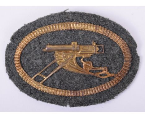 Machine Gunner Qualification Arm Badge, the oval machine gunners arm badge measuring 8 x 5.5cm with the stamped metal image o