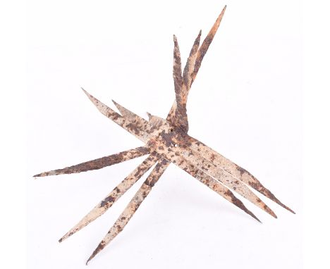Battlefield Recovered Anti-Personnel Spike, a 12 spiked anti-personnel item recovered from the battlefield, corroded overall 