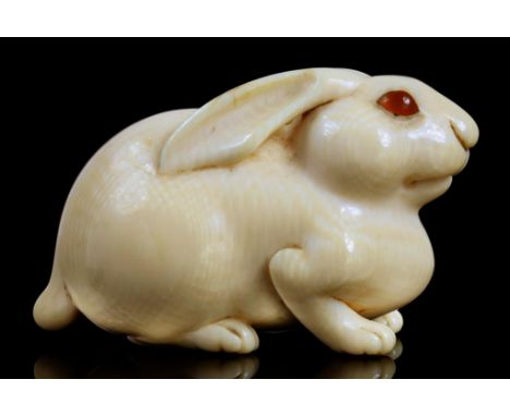 A JAPANESE IVORY NETSUKE OF A HARE, OSAKA SCHOOL, EDO/MEIJI PERIOD, 19TH C  unsigned, 5.2cm l A delightful netsuke, closely r