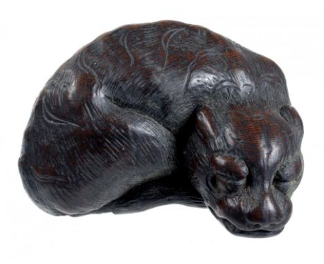 A JAPANESE WOOD NETSUKE OF A TIGER,  SIGNED TAMETAKA, NAGOYA SCHOOL, 1871-1788  4.8cm l For comparable examples see Bonhams F