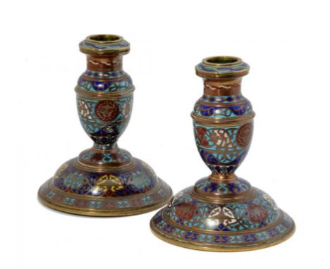 A PAIR OF ELKINGTON & CO GILT BRASS AND CHAMPLEVE ENAMEL DWARF CANDLESTICKS, C1870 14cm h, mark embossed on a triangular pad 
