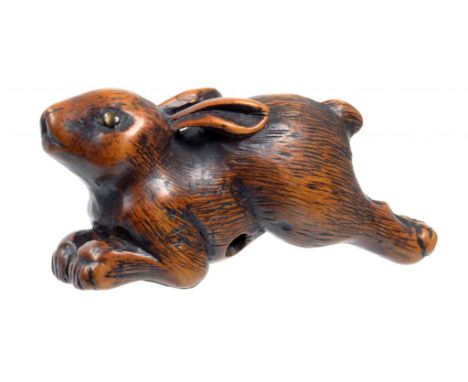 A JAPANESE WOOD NETSUKE OF A RUNNING HARE, SIGNED YOSHITSUGU, EDO PERIOD, 18TH C  the eyes inlaid, 6.3cm l See Davey (N), Net