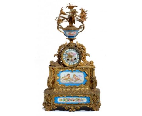 A FRENCH GILT BRASS MANTLE CLOCK INSET WITH SÈVRES STYLE PORCELAIN PLAQUES, C1880 the drum cased movement surmounted by a vas